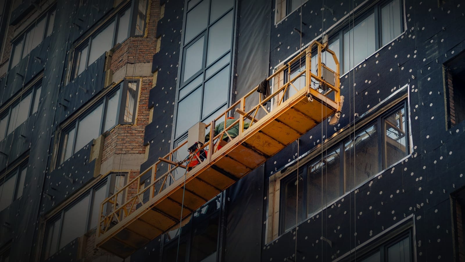Ventilated rainscreen facade under construction, showing the cavity behind the cladding